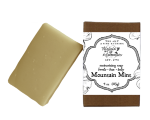 A scrumptious bar of handmade soap alongside its recycled-fiber kraft box.