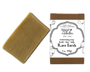 A scrumptious bar of handmade soap alongside its recycled-fiber kraft box.